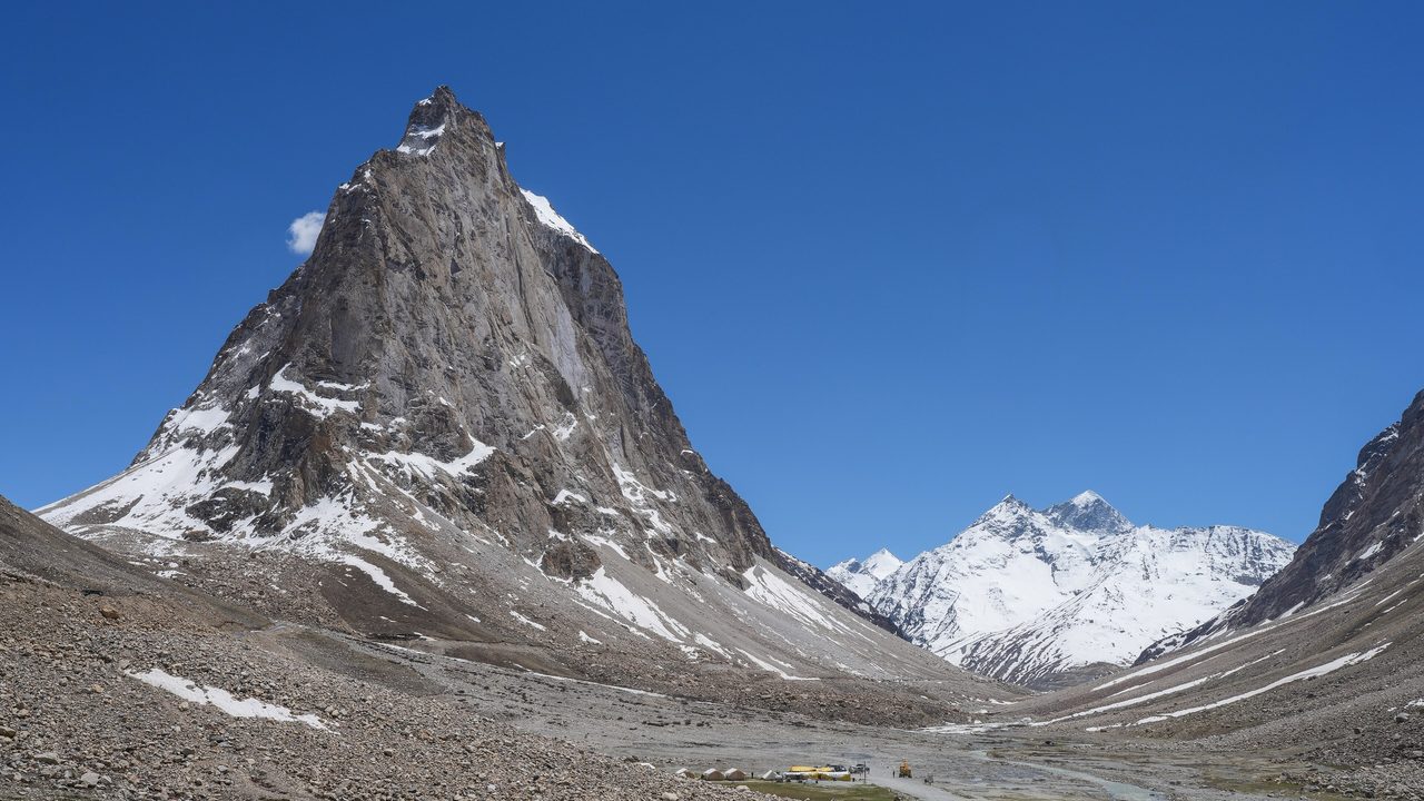 A snow-streaked rock pyramid rising above a Zanskar valley